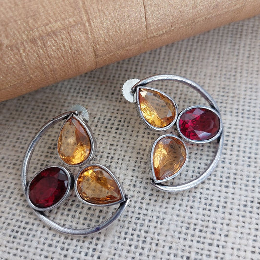 Sunset Symphony: Silver-Toned Ear Studs with Yellow and Red Stone"