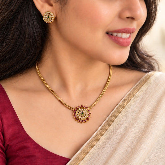 Aarunya: Gold Toned Festive Pendant and Earring Set
