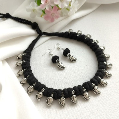 Desi Threads: Black Thread Bead and Silver Mango Motif Necklace and Earring