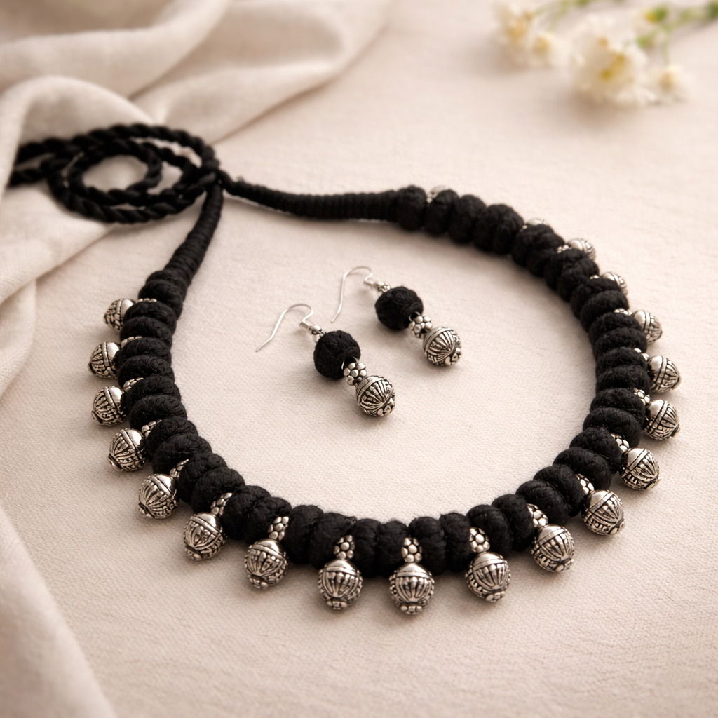 Desi Threads: Black Thread Bead and Silver Bead Motif Necklace and Earring