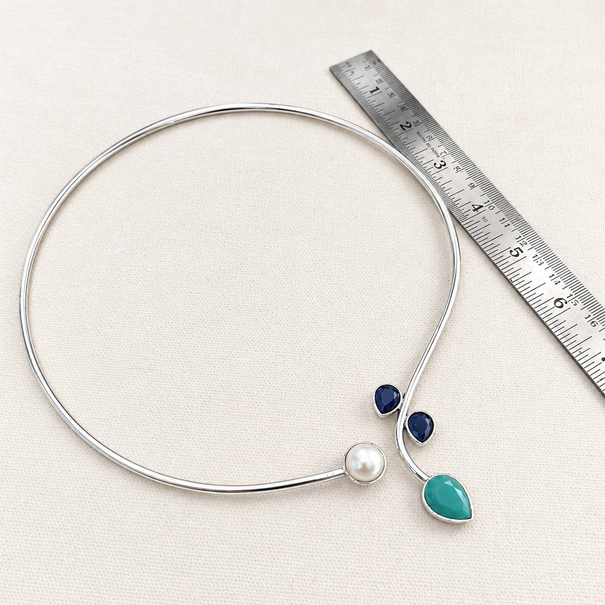 Rajata : Silver Toned Hasli with Pearl , Teal, and Deep Blue Stones