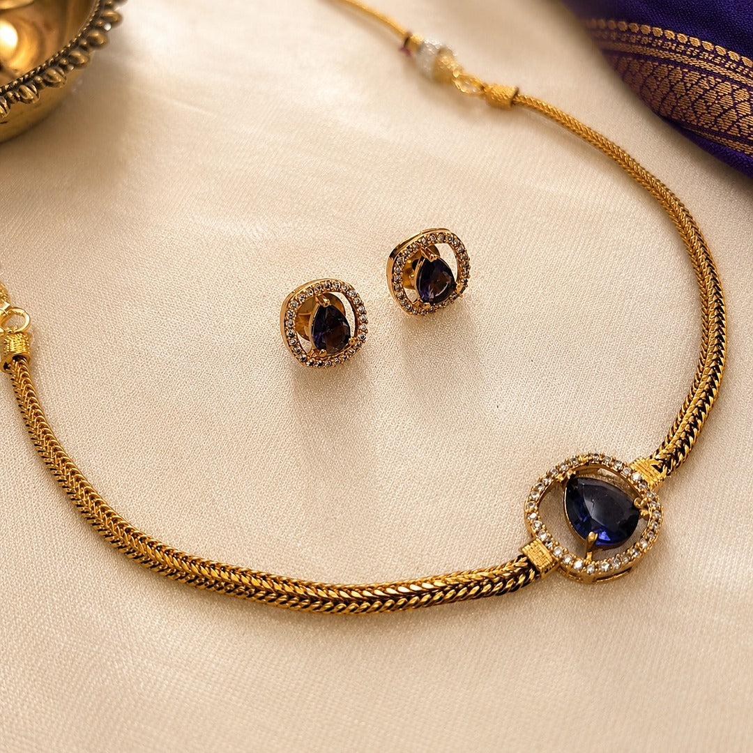 Abhaa: Minamalist Purple Stone Gold Toned Necklace and Earring Set