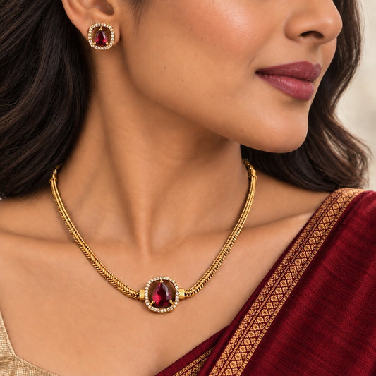 Aabha: Minamalist Ruby Stone Gold Toned Necklace and Earring Set