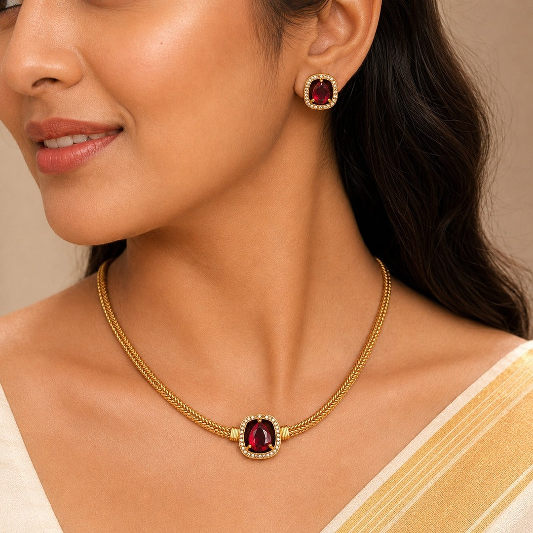 Aabha: Minamalist Ruby Stone Gold Toned Necklace and Earring Set