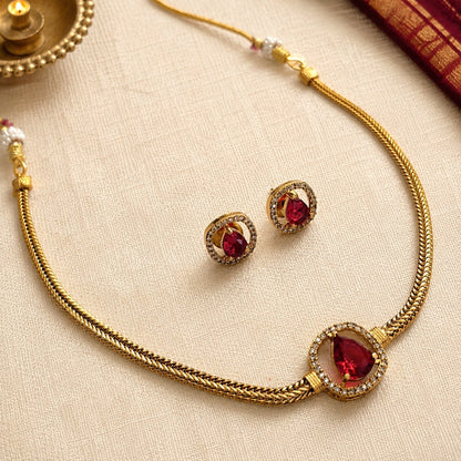 Aabha: Minamalist Ruby Stone Gold Toned Necklace and Earring Set