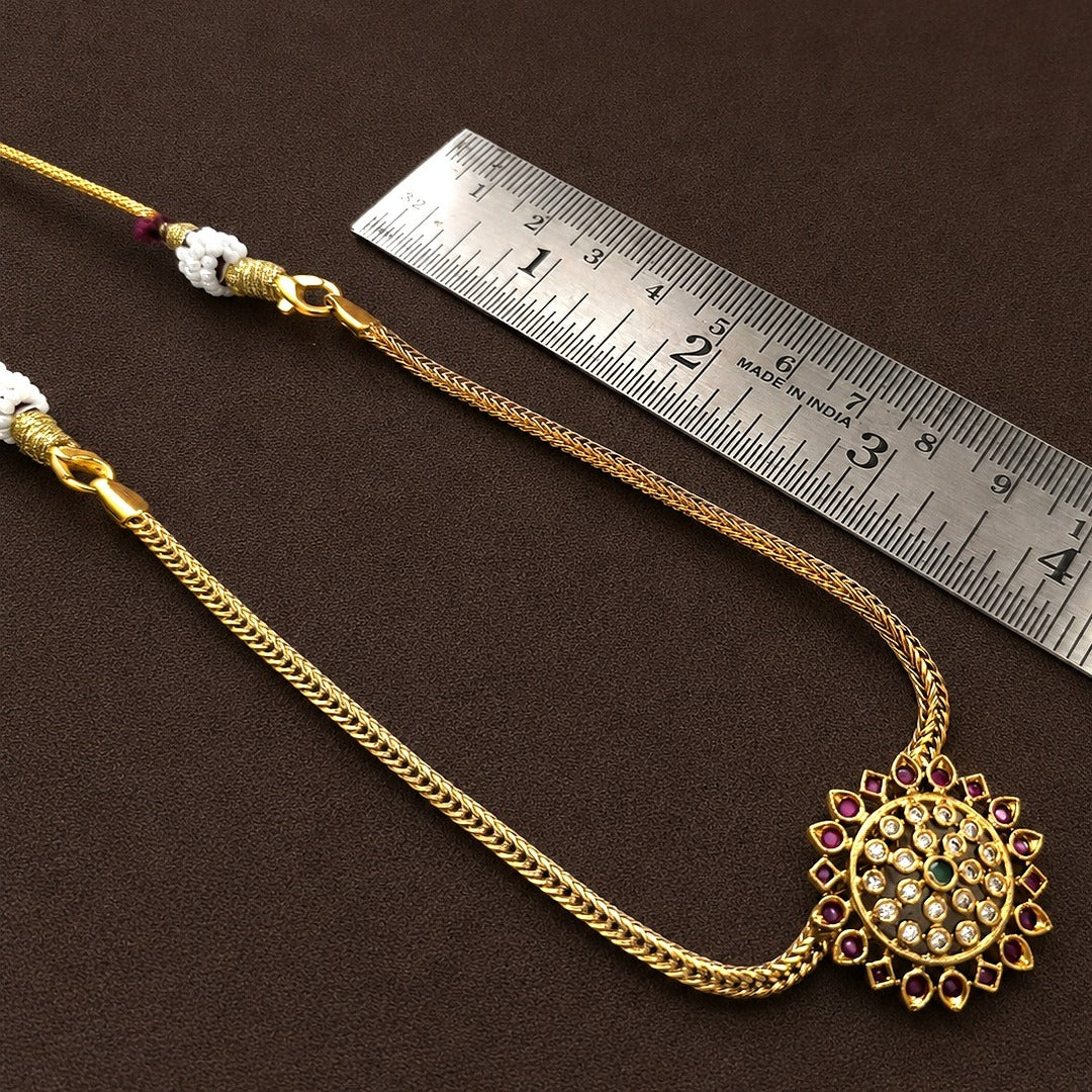 Aarunya: Gold Toned Festive Pendant and Earring Set