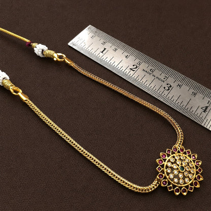 Aarunya: Gold Toned Festive Pendant and Earring Set