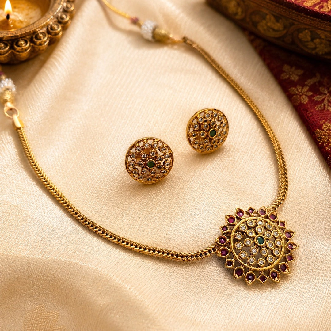 Aarunya: Gold Toned Festive Pendant and Earring Set