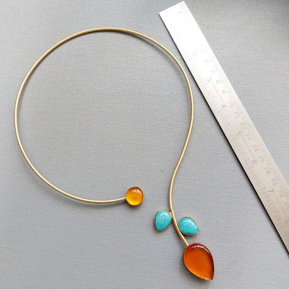 Sunset Skyline: Vibrant Orange and Blue Stone Studded Hasli Brass Necklace