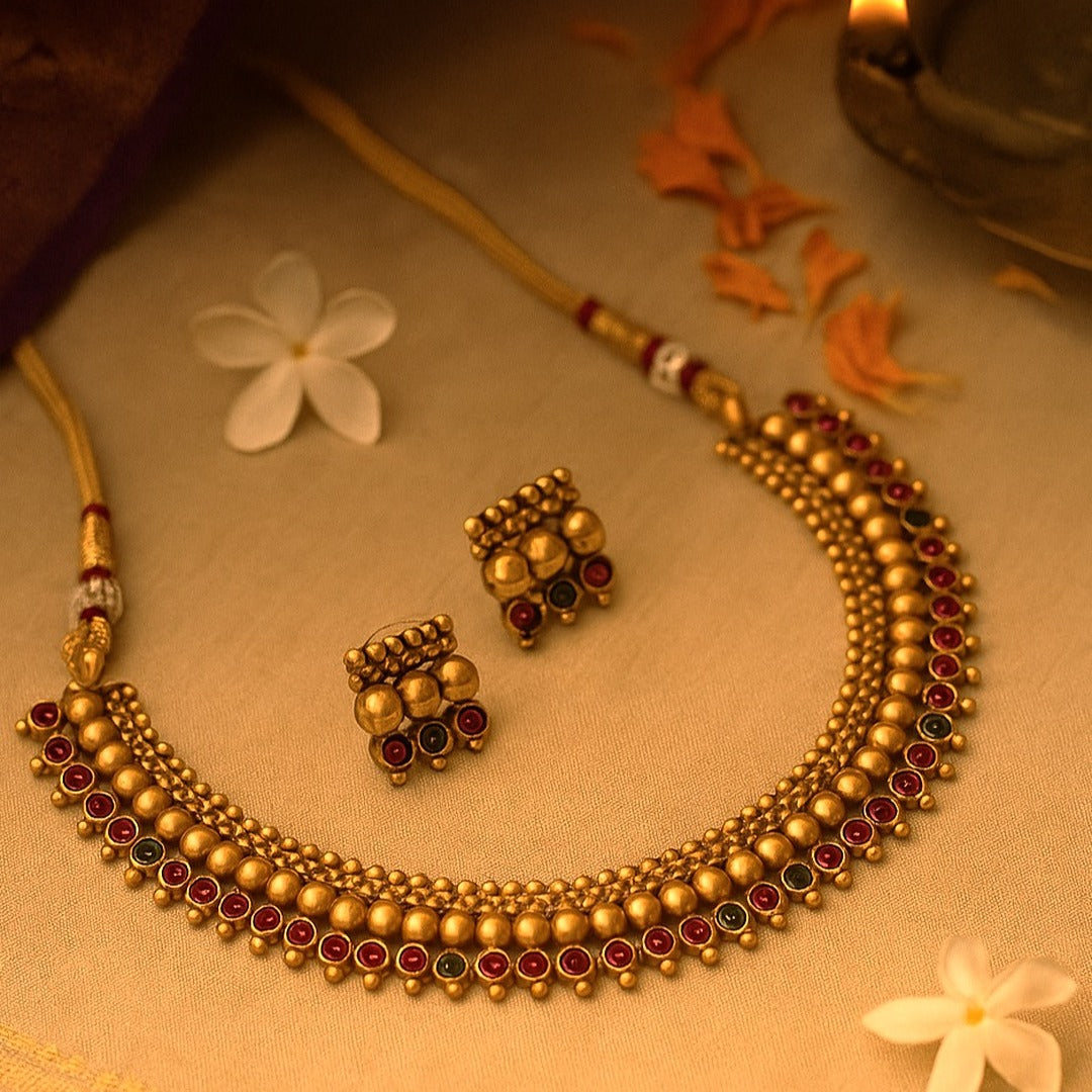 Tavisha: Antique Gold Toned Stone Studded Necklace and Earring Set