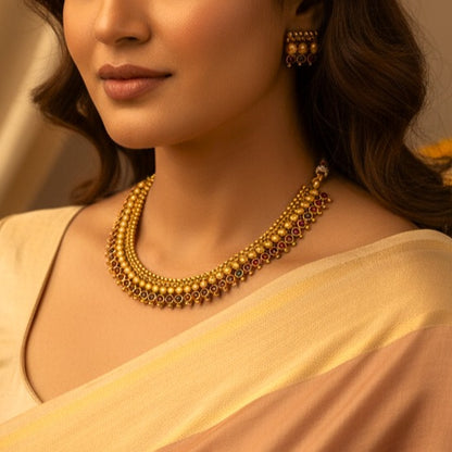 Tavisha: Antique Gold Toned Stone Studded Necklace and Earring Set