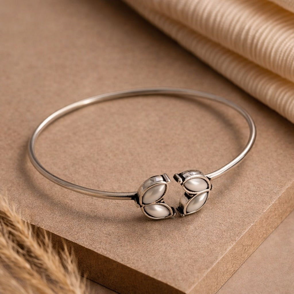 Twin Leaf Glow: Silver Toned Pearl Bracelet