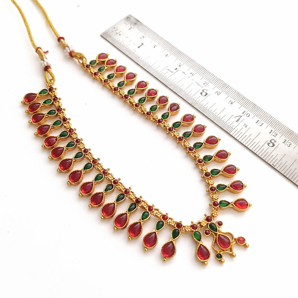Varnika: Traditional Gold Toned Stone Studded Necklace and Earring Set