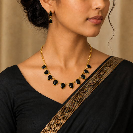 Nishka: Gold Toned Black Stone Necklace and Earring Set